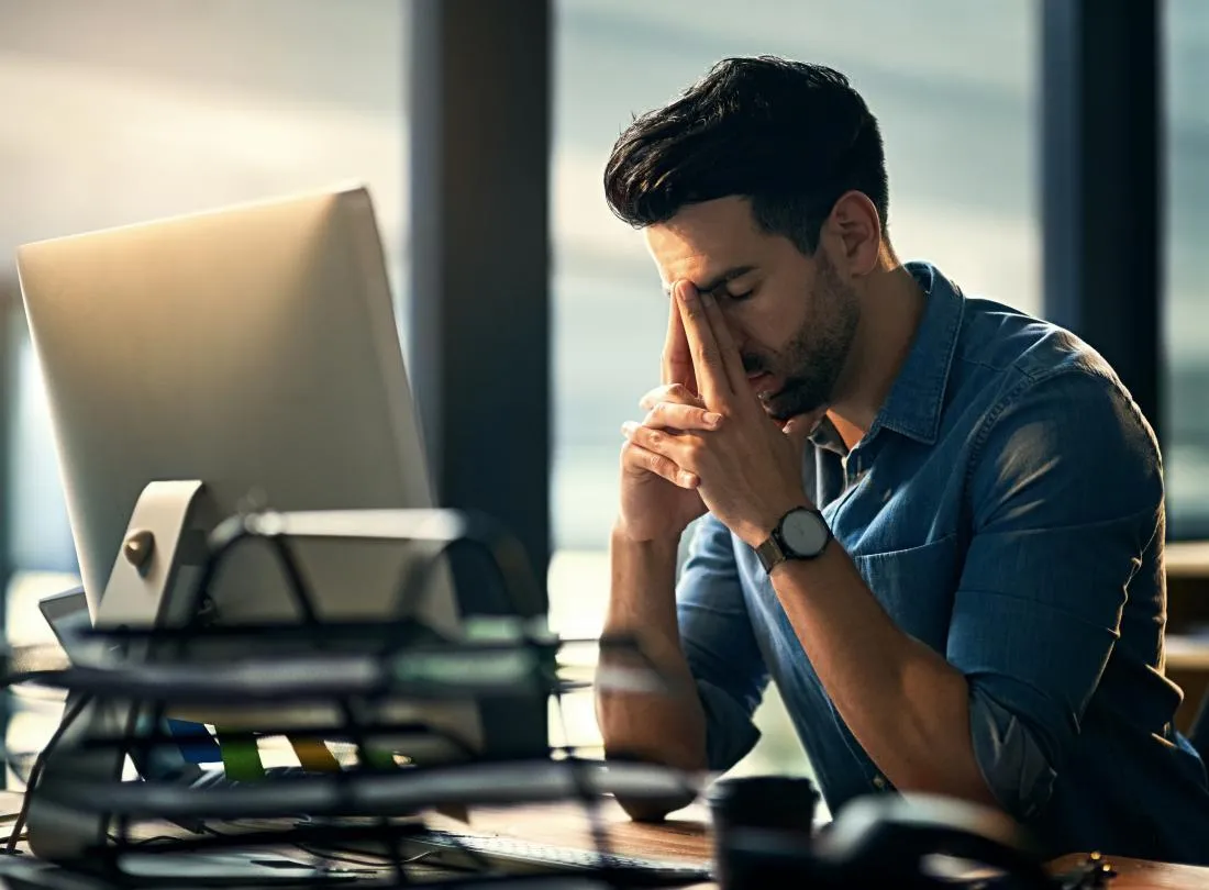 man-sitting-at-desk-at-work-stressed-and-tired.jpg