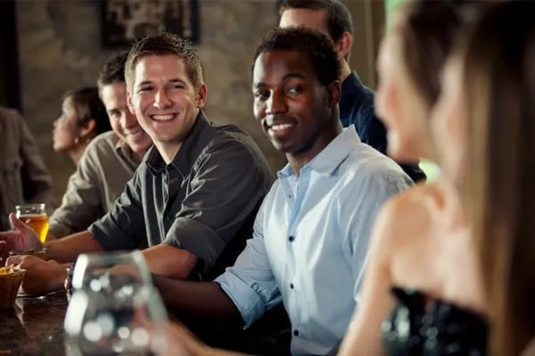 woman-flirting-with-group-of-men-at-bar-LILY