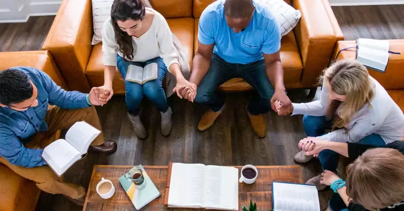 13858-bible-study-friends-holding-hands-praying-for.webp