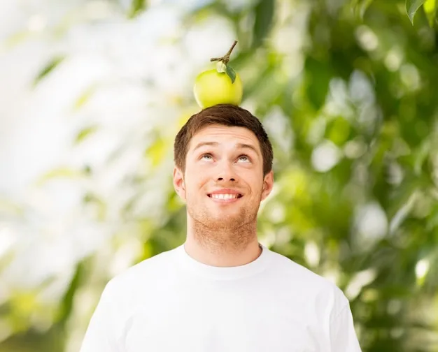 Premium Photo | Happy young man with green apple on his head