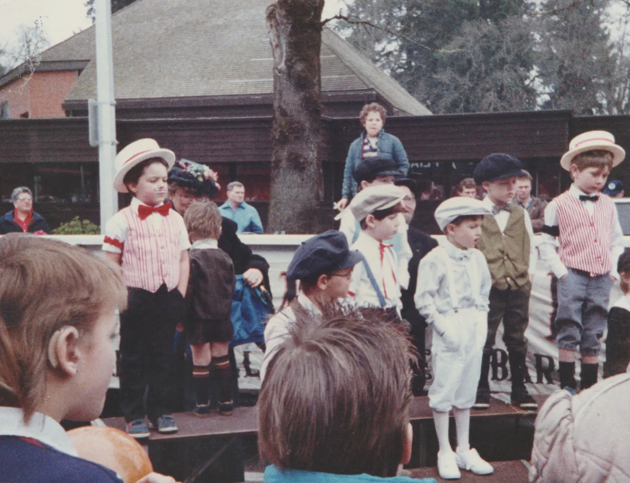 1990s - Crystal or Katie in the 1980s - Looks like Crystal and little bit like Katie, a girl winning a blue ribbon, other random kids ona  stage-2.png