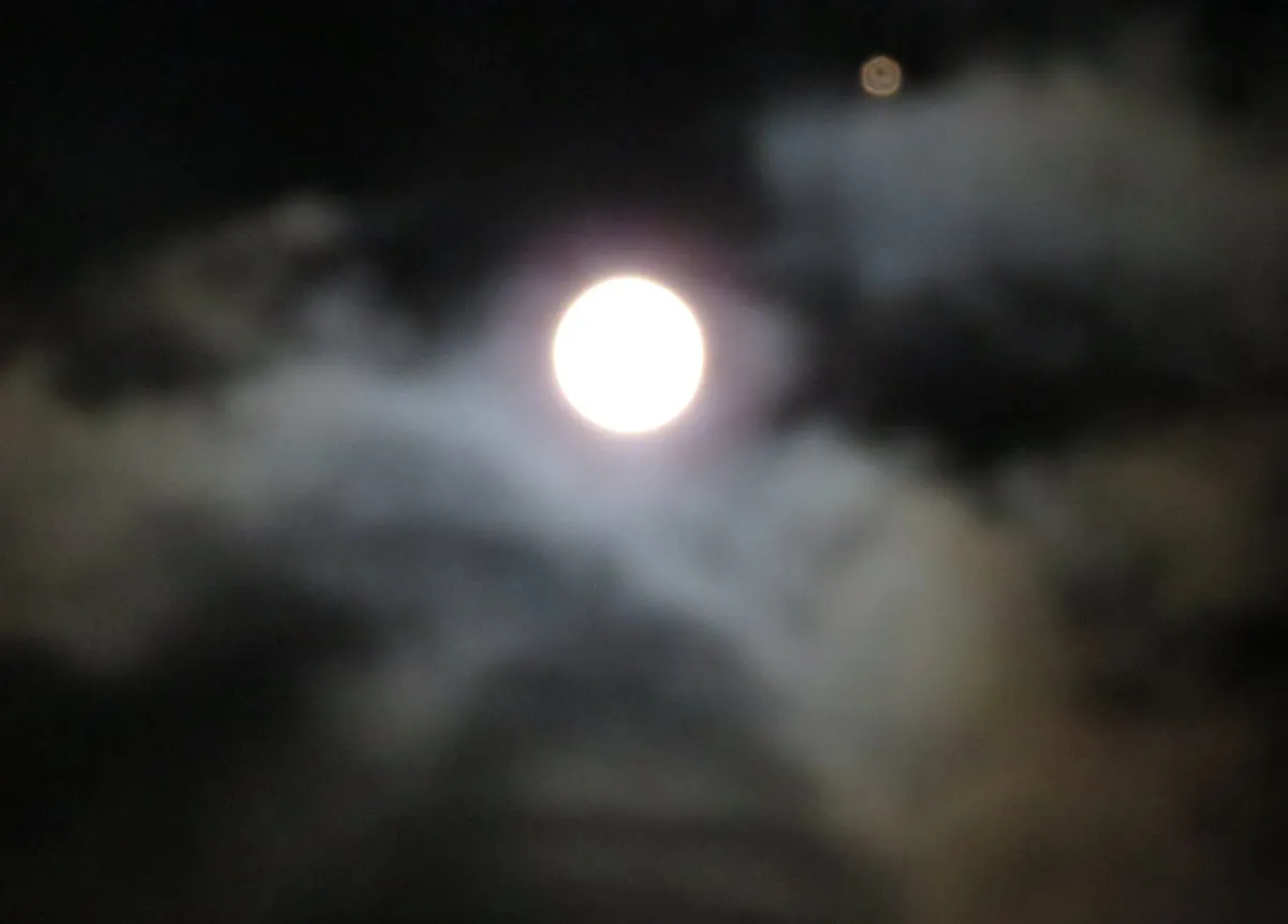 close view of full moon and bright orange star.JPG
