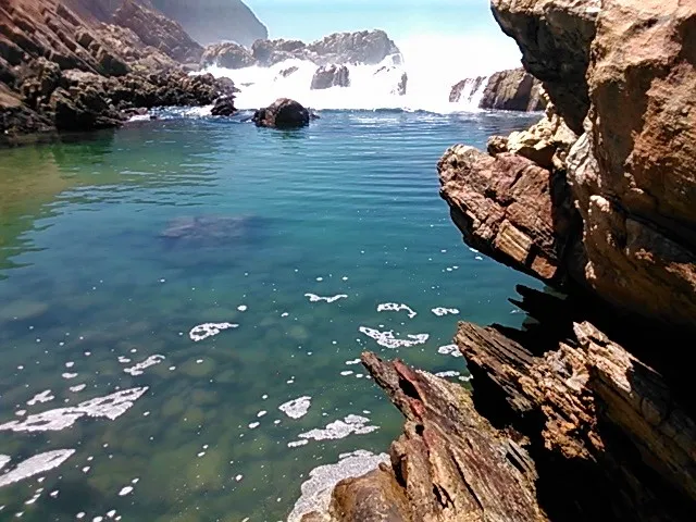 Water pours in from the ocean to fill the pool.