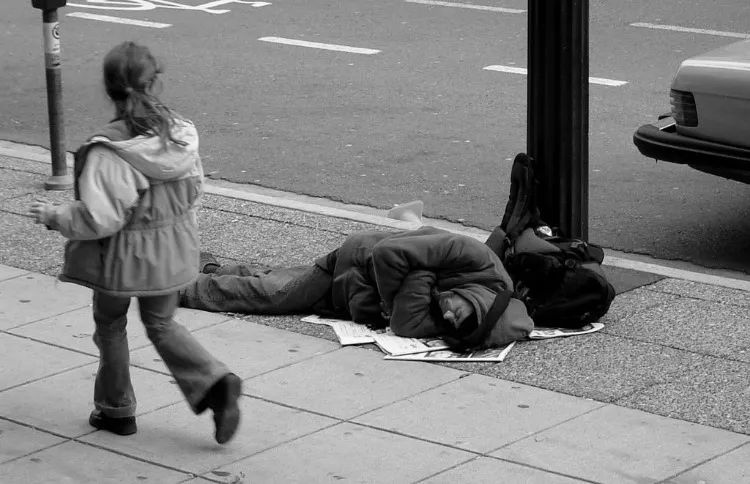 homeless-Man_sleeping_on_Canadian_sidewalk (1).jpg