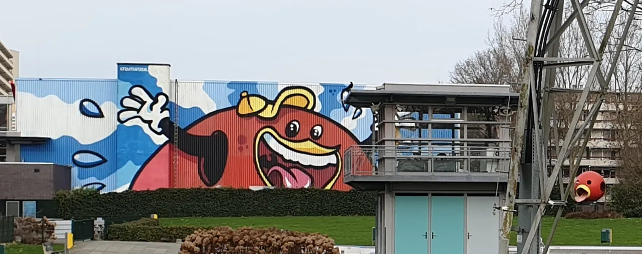 Mural on the side of the pool, with the famous slide on the right