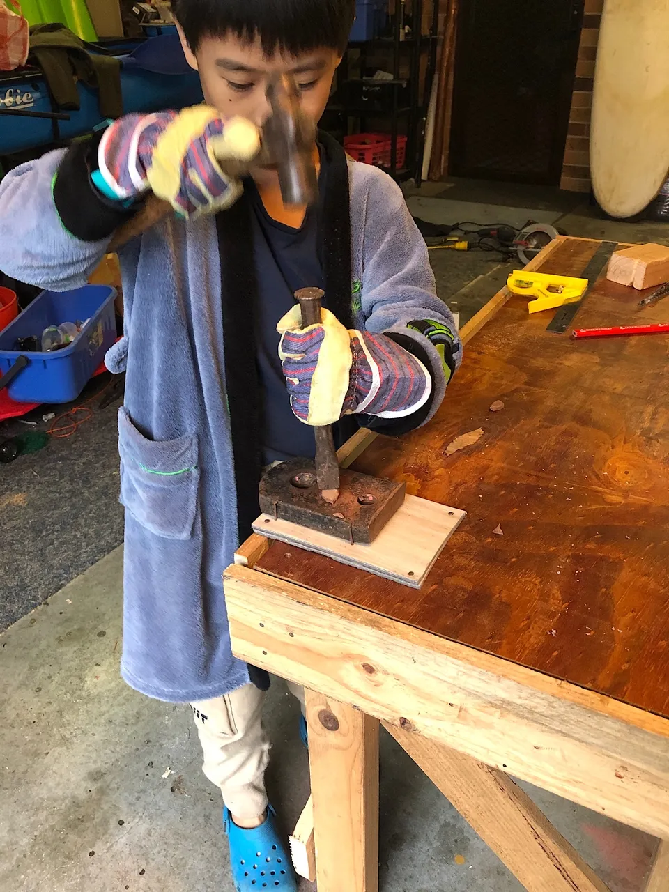 Testing his workbench anvil