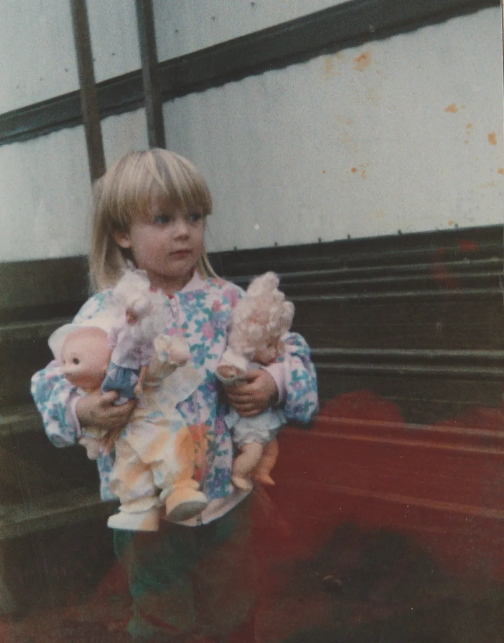 1992-12 - Crystal holding dolls, Christmas, December, could be 92 but it says 93, next to our house, near porch 2.png