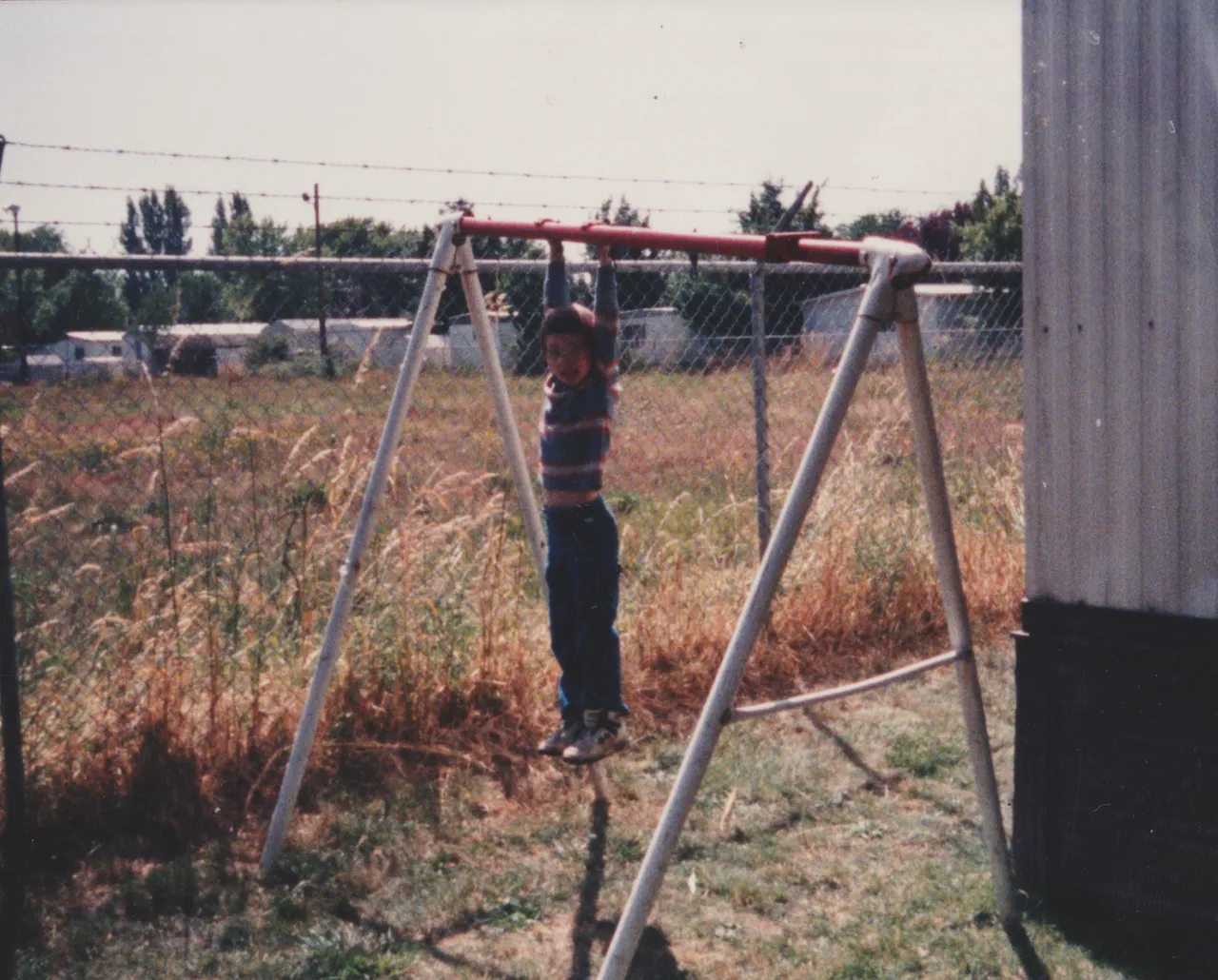 1992-07 apx Joey Monkey Bars Front Yard Near Fence.png