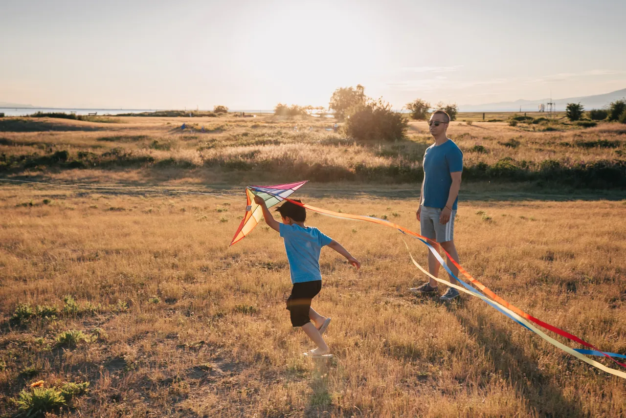 Father and son fly kites