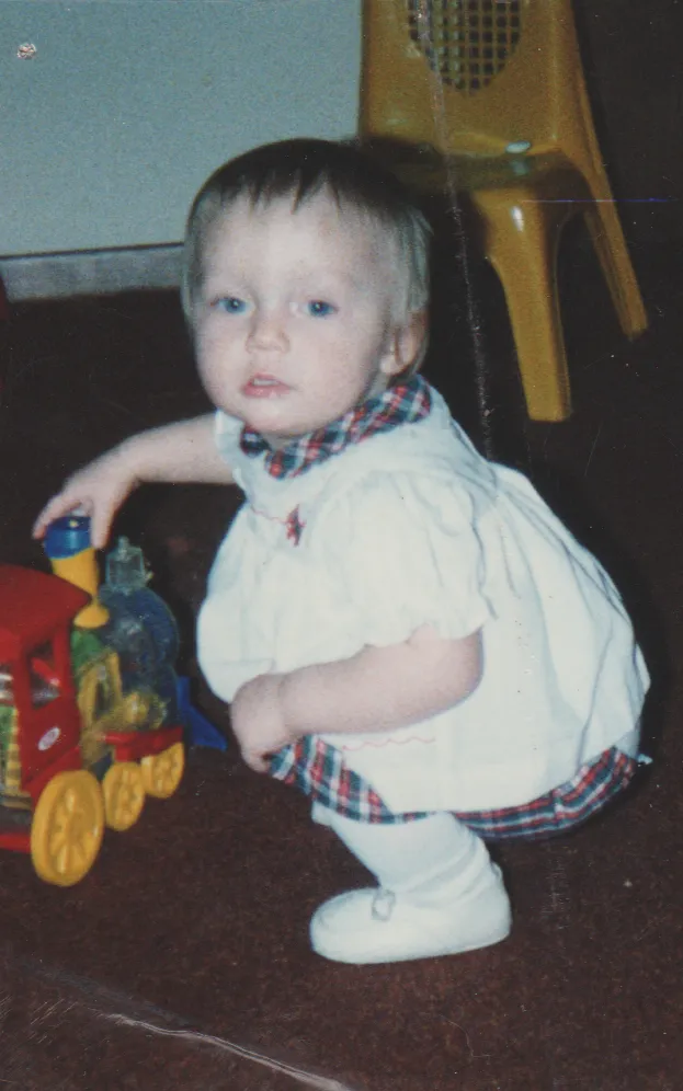 1992 - Crystal with a toy train at ccbc nursery - apx year.png