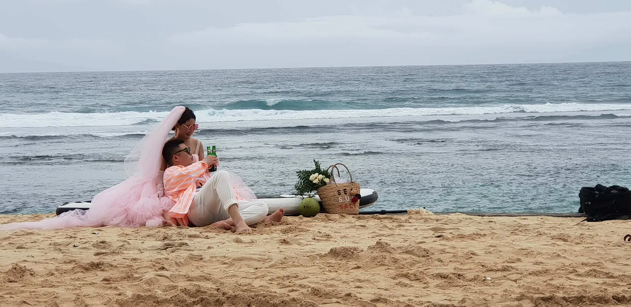 A couple posing for a photoshoot at the Melasti beach