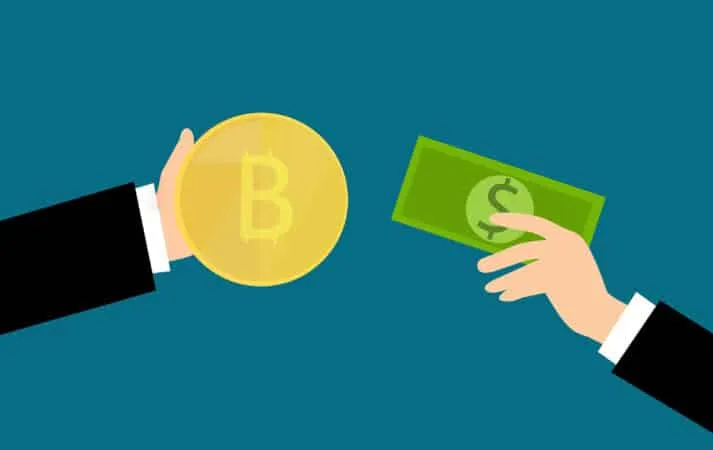 Hoe bitcoin te kopen met contant geld: een cartoon afbeelding van twee handen, een met een bitcoin, de ander een dollarbiljet.