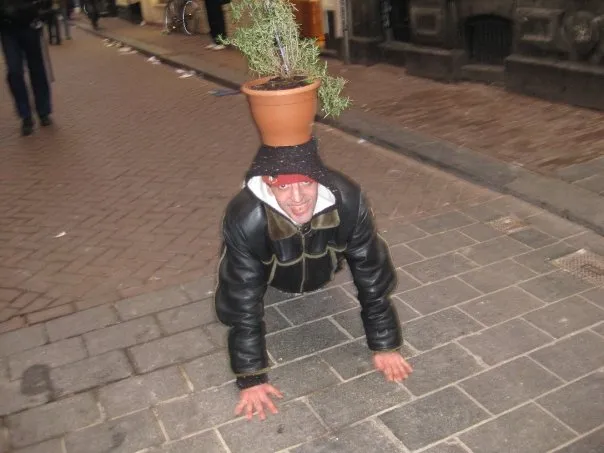 A guy doing push-ups with a plant pot on his head. Because, why not.