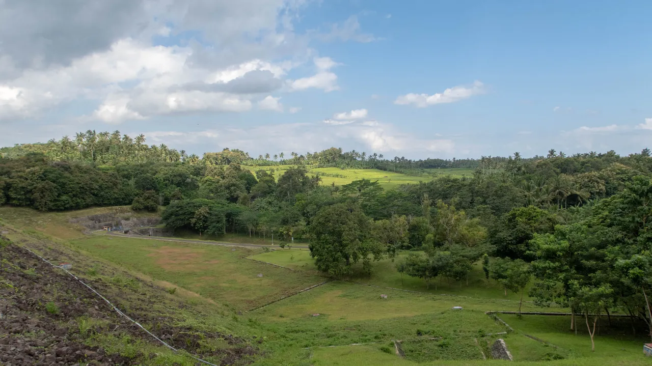 The rice farms at a distance which got water from this dam.