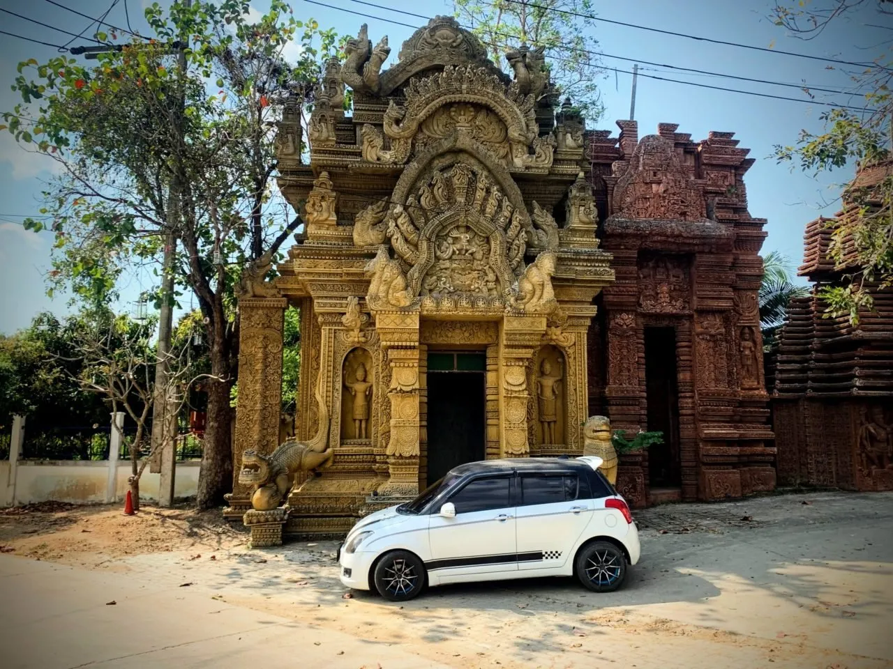 Suzuki Swift outside a mock temple