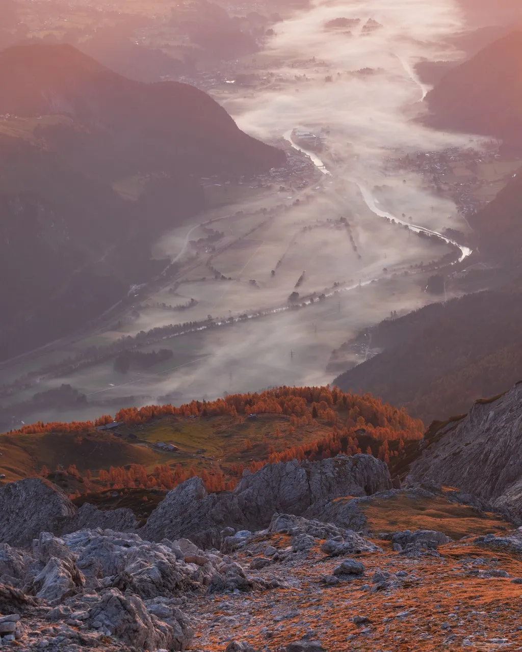 Morning view from the autumnal mountain Hochstadel down to the foggy Drautal Valley (October 2019)