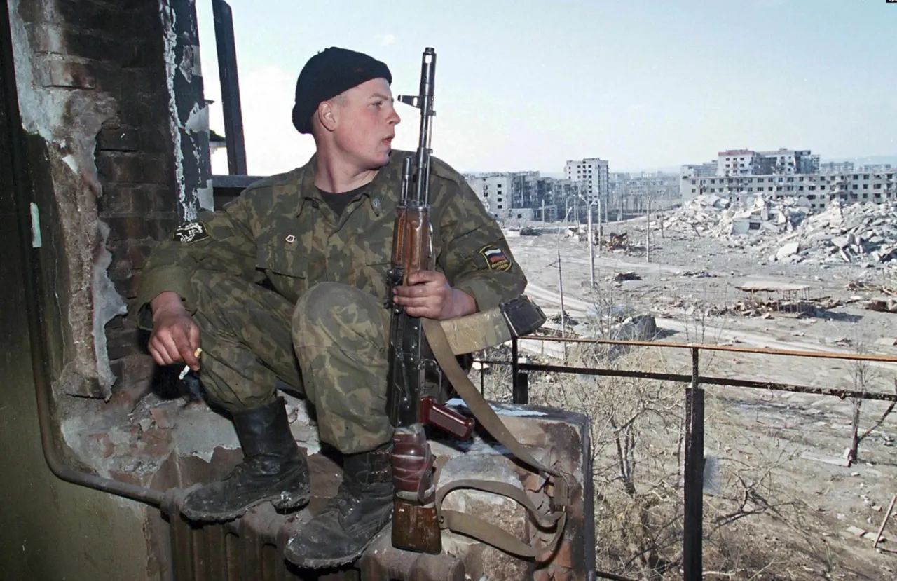 A Russian soldier against the background of a destroyed Chechen city. Photo Source - Ukrainer