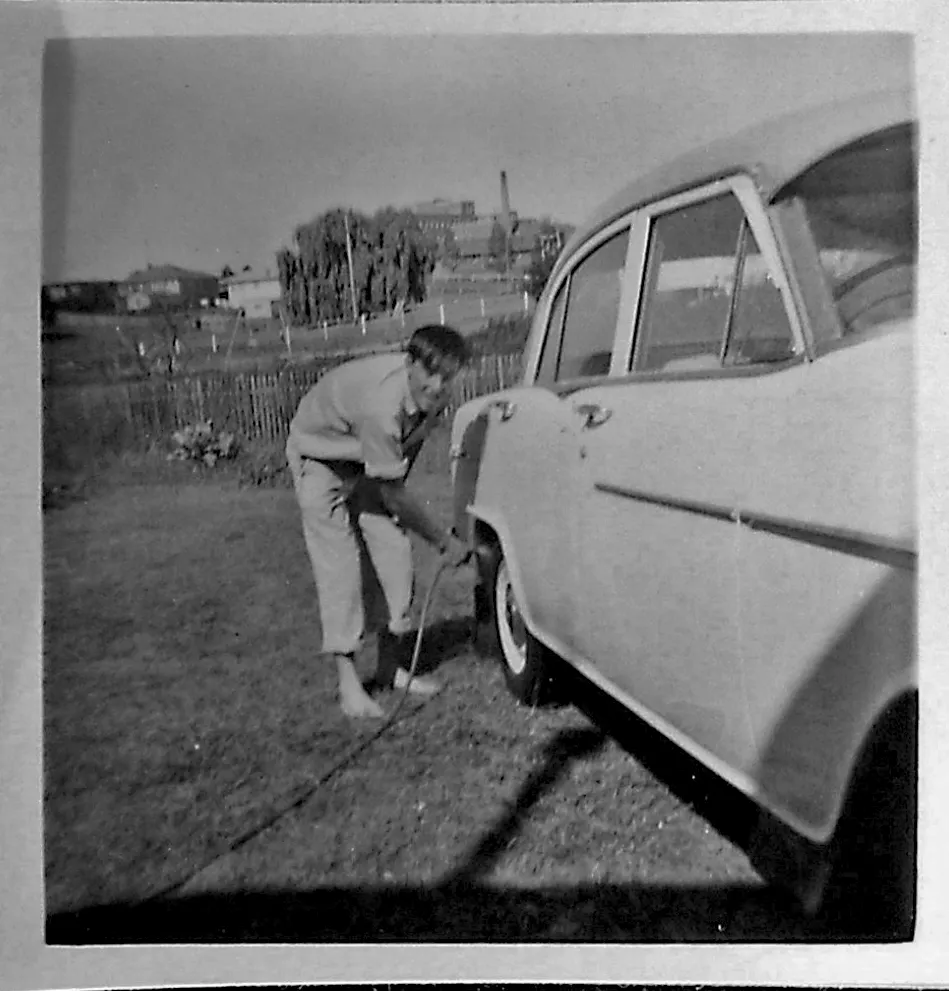 A YOUNG DAD WASHING THE CAR.png