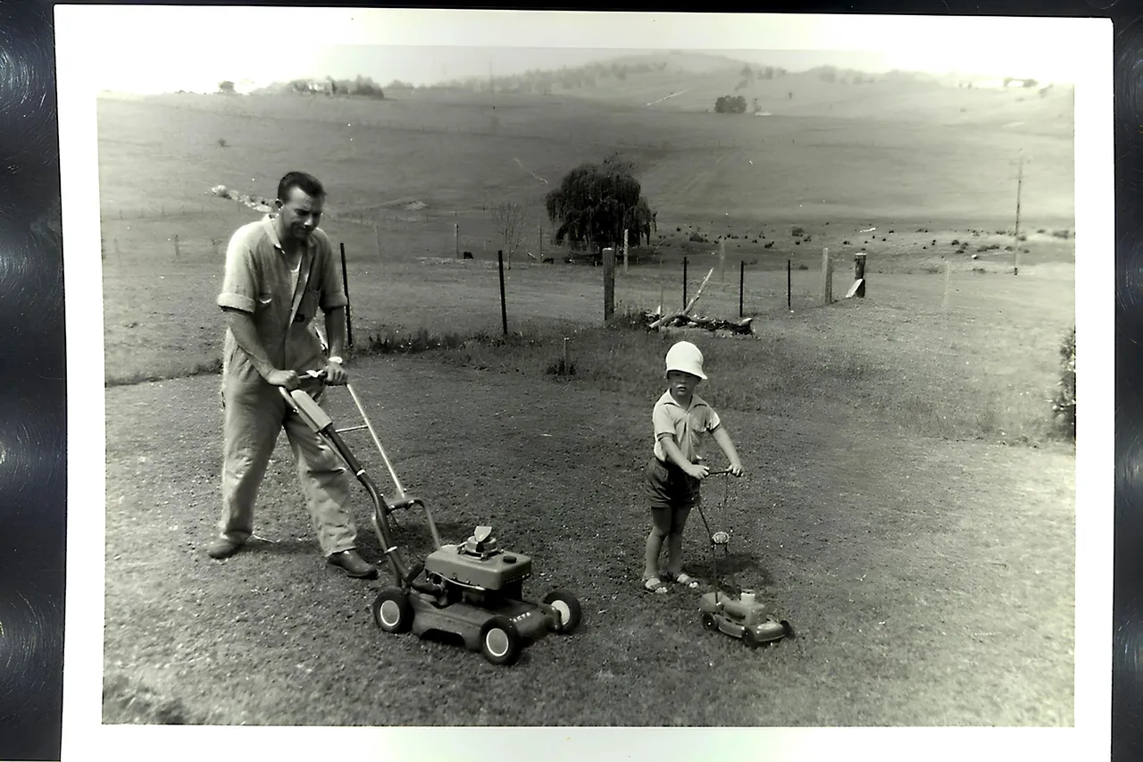 YOUNG DAD AND STEVE MOWING THE BACKYARD.JPG