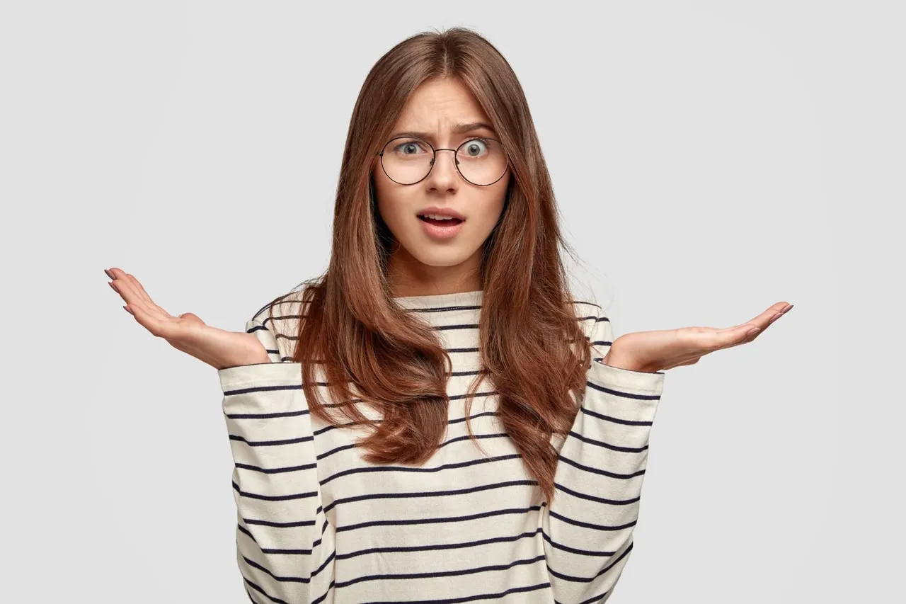 questioned-indignant-pleasant-looking-brunette-woman-with-hands-in-hesitant-gesture-wears-striped-casual-sweater.jpg