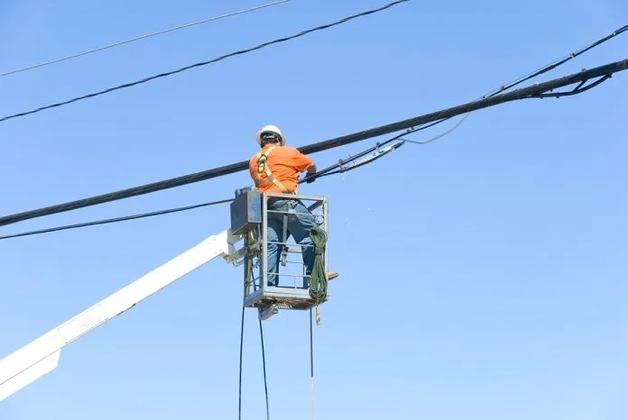 bigstock-Man-Working-On-Power-Lines-2188929-696x466.jpg