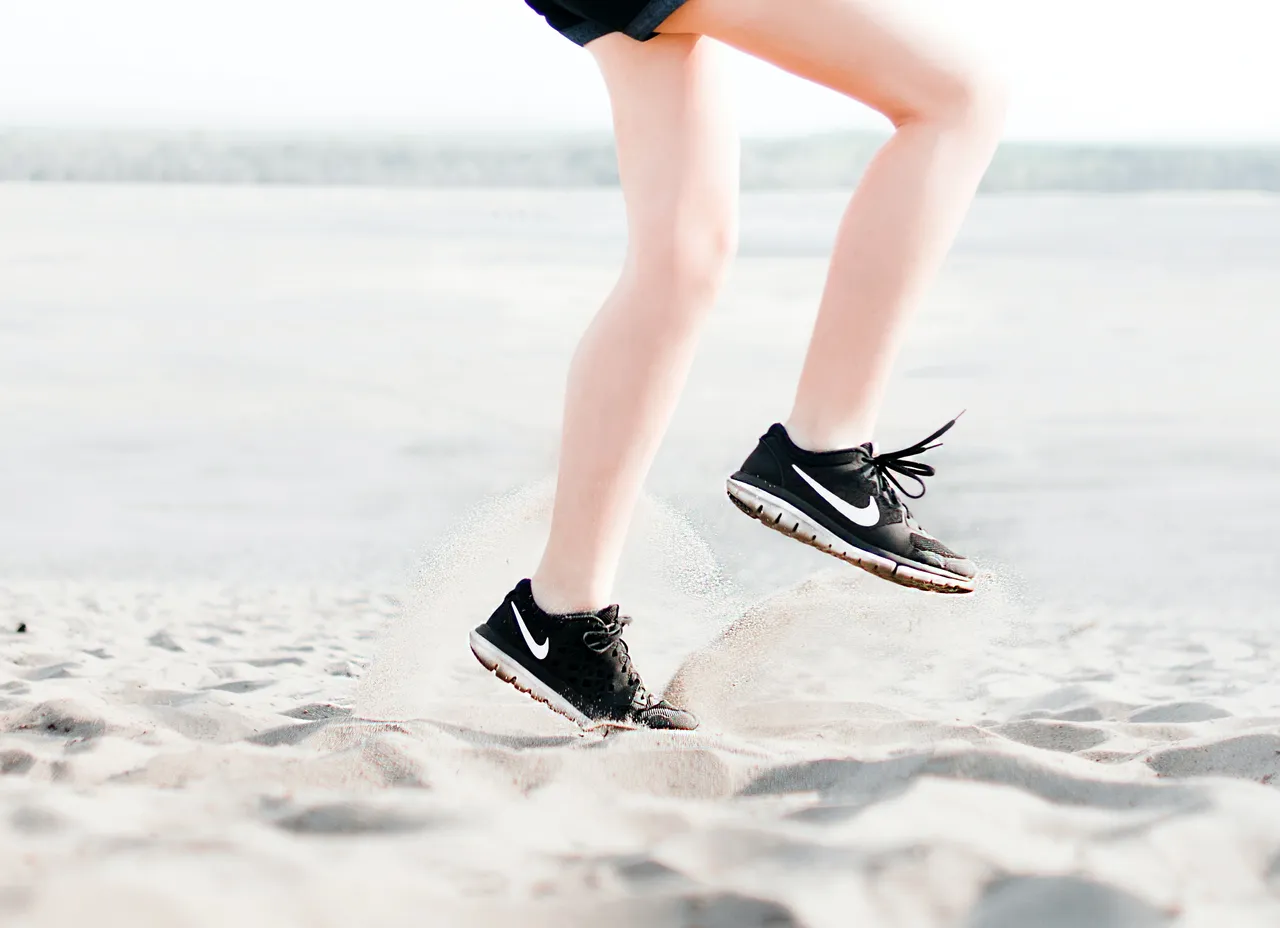 photo-of-woman-wearing-pair-of-black-nike-running-shoes-1166868.jpg