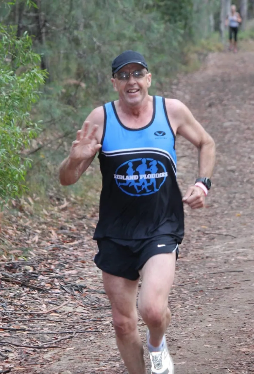 Over the many years of running and being photographed in races and at parkruns, I’ve learned to smile and wave, even when I’m hurting!